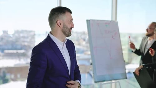 Man Presenting to Colleagues in Bright Modern Office