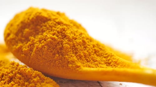 Detail Shot of Turmeric Root Powder on Spoon