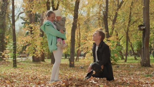 Family Bonds Shown Through Gentle Touch and Playful Interaction Warm Family Gathering in Park