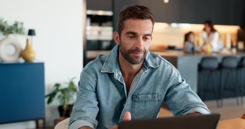 Man Working on Laptop at Home