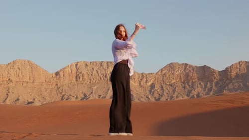 Teen Girl Making Selfie in Desert with Smartphone Travel Lifestyle