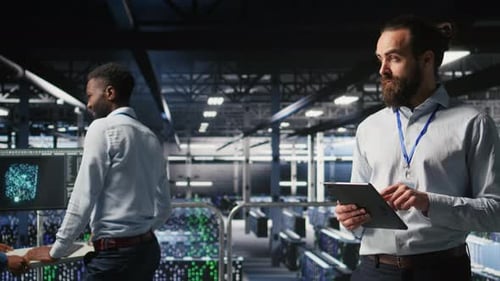 Server Room Technician Next to Coworkers Reviewing AI LLM Visualization