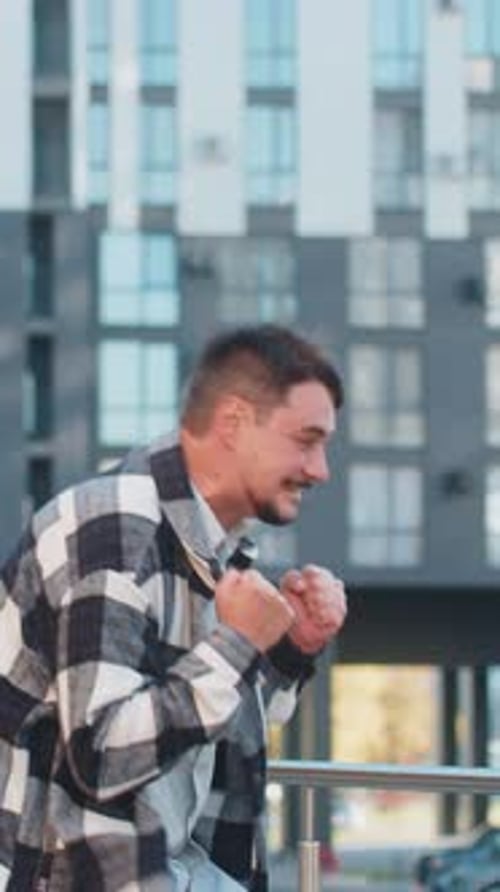 Excited Man Looking Surprised Clenching Fists Shocked By Sudden Victory Standing on City Street