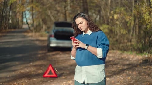 Travel Troubles Distraught Girl on the Phone Reporting Car Trouble in Workshop