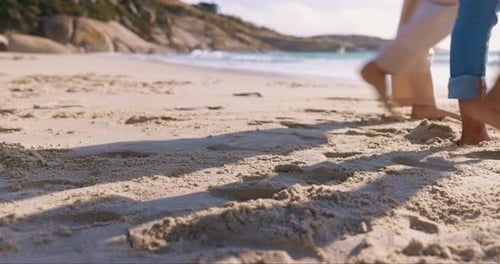 Couple, love and holding hands at beach, walking and romance outdoor on holiday date