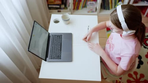 Teenage Girl Studying Online at Home