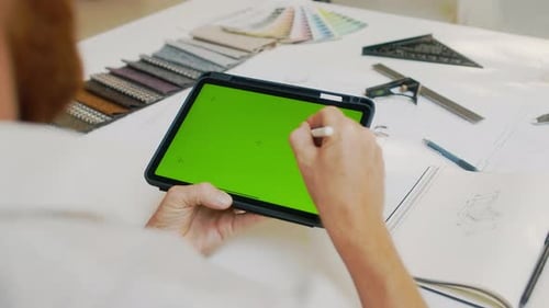 Man Drawing with Stylus on Digital Tablet with Green Screen