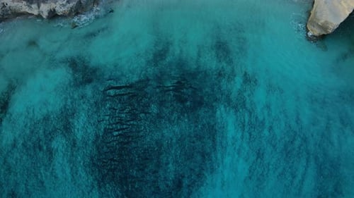 Turquoise coral reef Cala Mitjana beach Menorca aerial