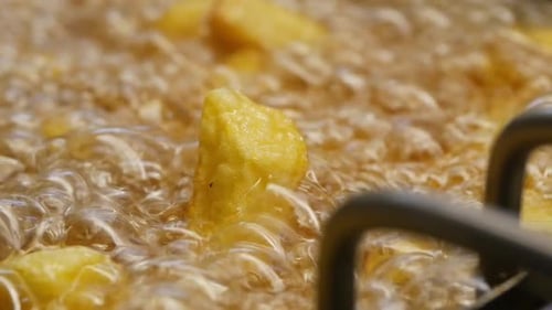 French Fries Being Deep Fried in Oil