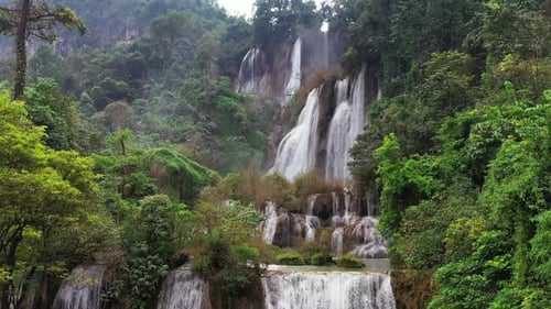 Beautiful Lush Jungle Waterfall Cascading Down A Verdant Tropical Cliff