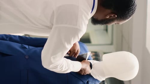 Vertical Video Employee Adding Pocket Square to Blazer