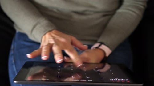 Woman Using Calendar on Tablet at Home