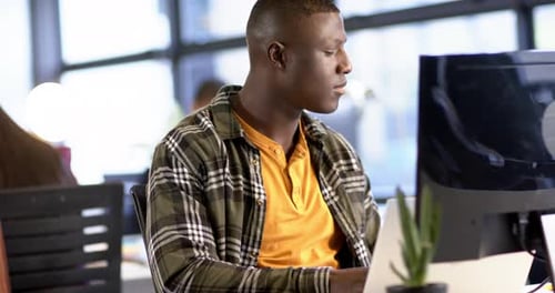 African american businessman using computer in office, slow motion, copy space