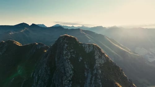Two people hiking up a mountain in the Alps in between Austria and Italy.