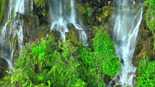 Beautiful waterfall in a tropical forest by aerial view from a drone.