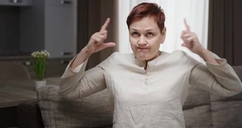 Woman Covers Ears in an Agitated State