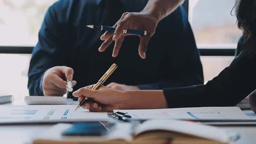 Business Team Discussing Charts and Graphs in Office
