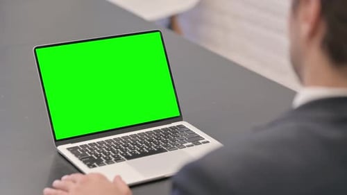 Businessman Using Laptop with Chroma Key Screen