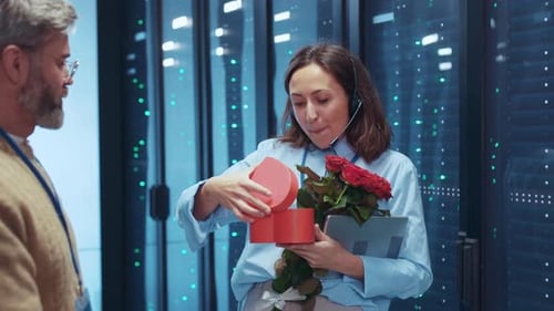 Man Surprises Woman With Flowers in Server Room