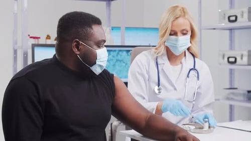 Doctor Administers Vaccine to Patient in Clinic