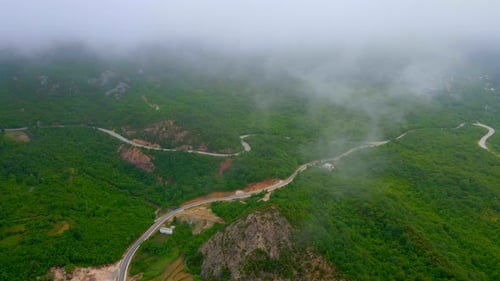 The Drone Video Captures a Breathtaking View of a Wide Green Valley Amidst Low Mountains with a