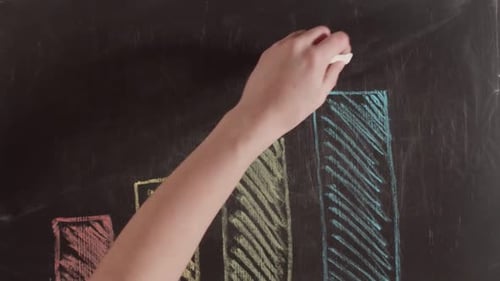 On the chalkboard colored crayons drawn a diagram with a arrow pointing down. Concept of regression