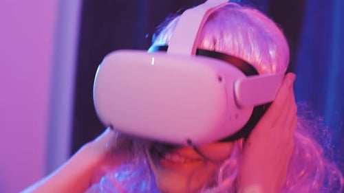 Smiling Young Adult Wearing VR Headset
