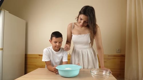 Woman and Child Baking in Bright Kitchen