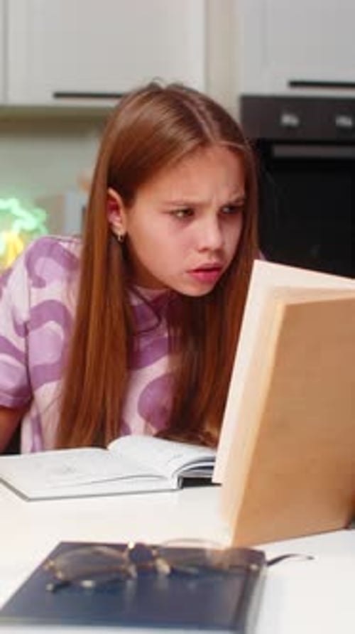 Teenager Girl Serious Homework Solves Tasks From Book Writes Notes in Notebook Deep Focus Study Math