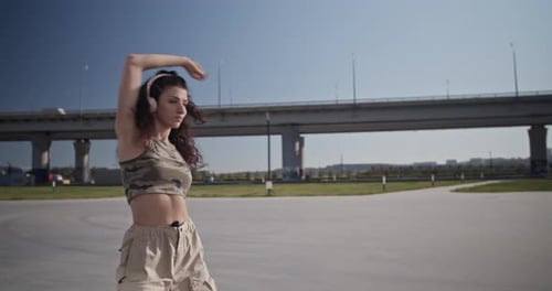 Woman Dancing in Urban Environment on Sunny Day
