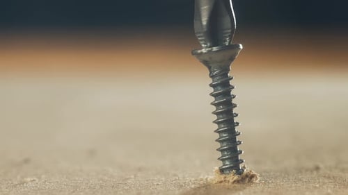 Screwdriver bit turns the screw into wood