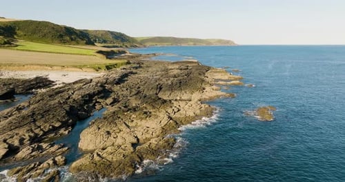 Flying Low Over Stunning Rocky Coastline On Clear Summer Day Aerial Drone View