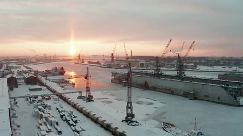 Atemberaubende Luftaufnahme des Industriehafens im Winter, voller Show. Gefrorene Küste. Goldenes l