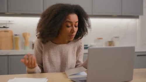 Woman Video Conferencing at Home With Laptop