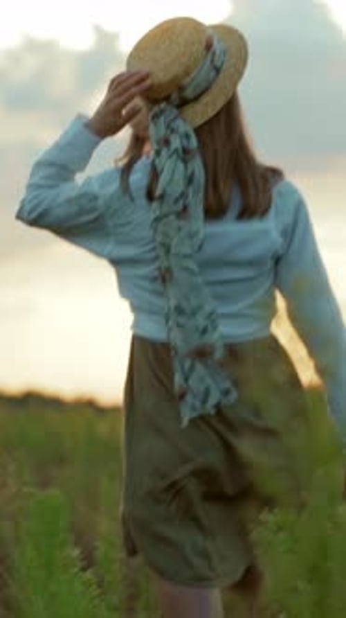 A Woman Enjoys a Serene Day in a Picturesque Field Embracing Nature