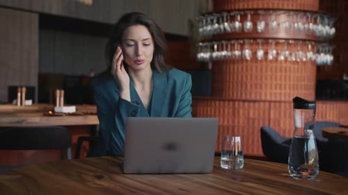 Woman in Business Suit Talking on Phone