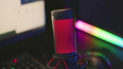 Close Up Condenser Mic with Red Light and Blurred Computer Setup
