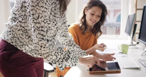 Business women, digital tablet and mentor with employee in office for training