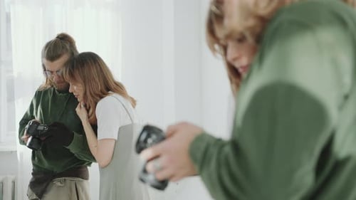 Photographer and Model Reviewing Images on Camera Display in Studio