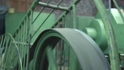 Industrial Green Belt Drives Machinery in Factory Setting