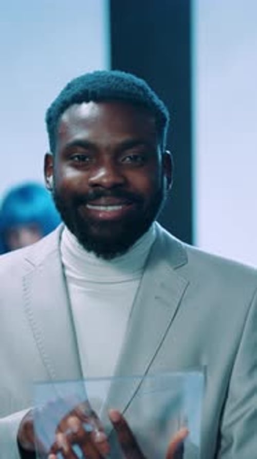 A Stylish and Professional Individual Utilizing Innovative Technology in a Modern Setting