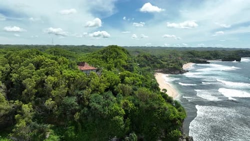 Aerial view of beautiful empty tropical beach and sea without visitors in Yogyakarta, Indonesia.