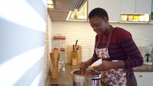 Woman Cooking Food in Kitchen in Home