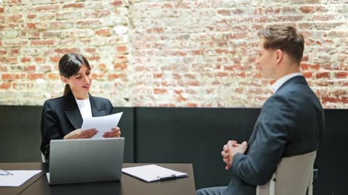 Businesswoman Interviews Businessman in Modern Office for Job Position