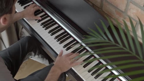 Adult Playing Electric Piano Indoors