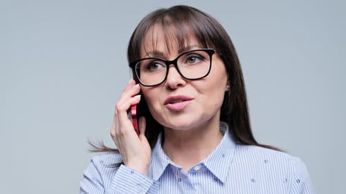 Woman Talking on Phone Wearing Glasses
