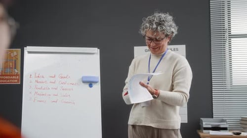 Smiling Woman Teaching Class in Prison with Inmates Listening
