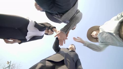 Team of Adults Joining Hands For Success