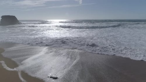 Aerial view beautiful beach with views of ocean waves and water crashing on to sandy beach