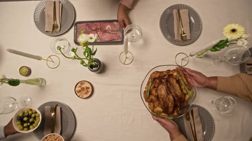 Family Serving Festive Dining Table with Turkey and Salads at Home Dinner